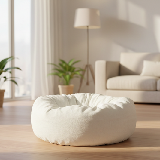 White bean bag chair in a living room with a couch and plants.